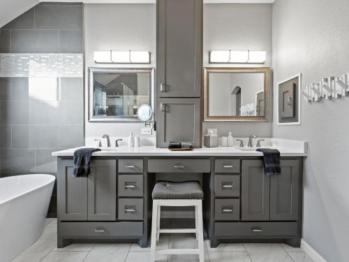 a bathroom with a sink and a bath tub at Boho Dreamscape 4BD Game Room Pool in The Colony