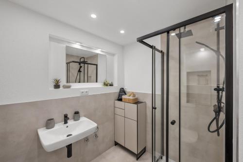 a bathroom with a sink and a shower at Exklusive City Apartments in Bad Kissingen