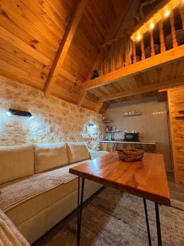 a living room with a couch and a wooden table at Vila Vrela in Žabljak