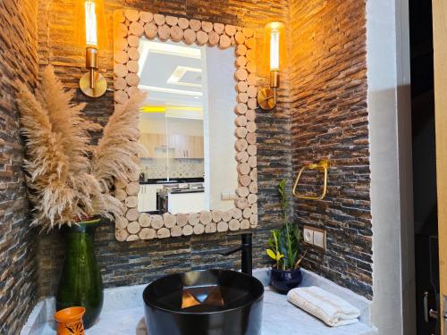 a bathroom with a mirror and a sink at Azur Apartment essaouira in Essaouira