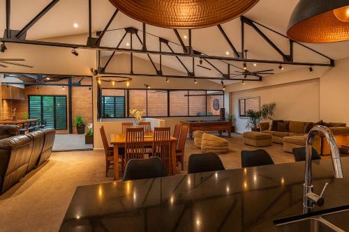 a kitchen and living room with a table and a living room at Newcastle Penthouse - Spa, Pool Table, City Centre in Wickham