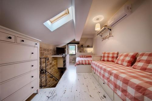 a bedroom with a couch and a bed in it at RIVA SUITE 2 in Komiža
