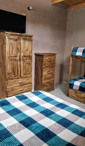 a bedroom with a bed and a dresser and bunk beds at El Shaddai I in Santiago del Estero