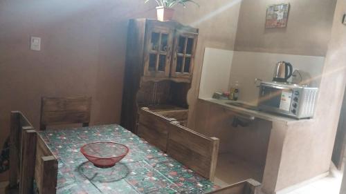 a small kitchen with a table and a microwave at El Shaddai I in Santiago del Estero