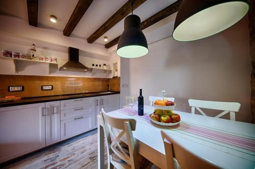 a kitchen with a table with a bowl of fruit on it at RIVA SUITE 2 in Komiža