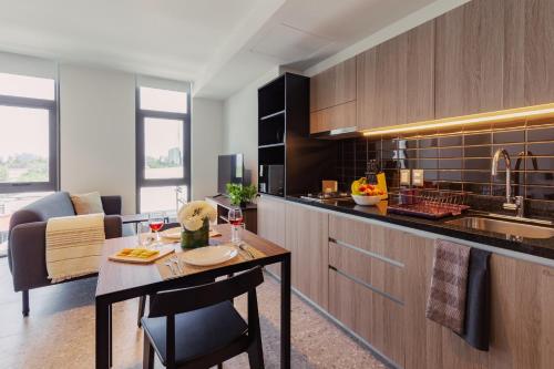 a kitchen with a table and a dining room at Stylish apartments by VIATO HOMES in Mexico City