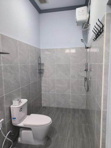 a bathroom with a toilet and a shower at Gama Stay in Lovina