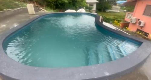a swimming pool with blue water in a yard at Boyce Guest House in Black Rock