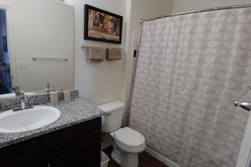 a bathroom with a shower and a toilet and a sink at 20 Minutes to Skiing in Midvale