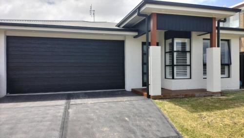 a garage door on a house at 5 mins to Lake Macquarie, 30 to Hunter Wineries in Teralba