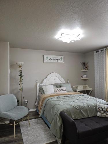 a bedroom with a bed and a chair and a chandelier at providing spare luxury rooms for rent in Pasco