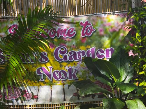 a sign that reads awhile to a garden nox at Suan's Nook Guest House in Larena