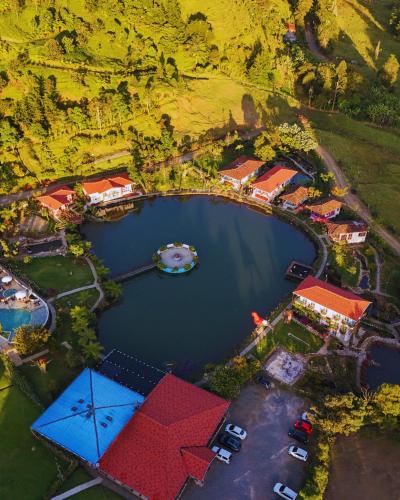 an aerial view of a resort with a boat in a lake at Hotel Lago Valdivia in Jardin