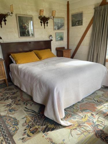 a bedroom with a large bed with a white blanket at Lear House Oamaru in Motungarara
