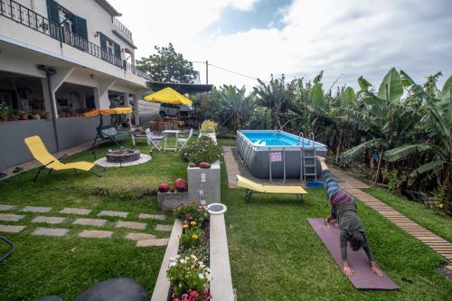 a backyard with a swimming pool and a house at Tabua Village Madeira Suite 5 Nature Lovers in Ribeira Brava