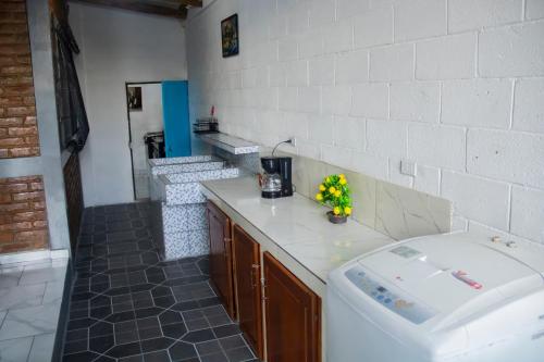 a kitchen with a counter and a sink in a room at Coco Cabana en Playa San Diego in San Diego