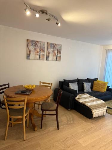 a living room with a table and a couch at Olive Den in Wolverhampton