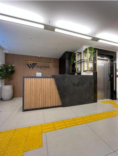 a lobby with a x intercept sign on the wall at West Fit Padrão 06 in Mossoró