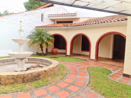 a courtyard with a fountain in front of a house at Mi pedacito de Cielo!!!! in La Banda