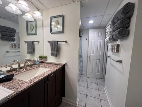a bathroom with a sink and a shower at Amazing View Beach Front King Bed in Panama City Beach