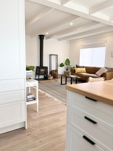 a living room with a couch and a fireplace at Little Red Gate Urban Retreat in Kingston