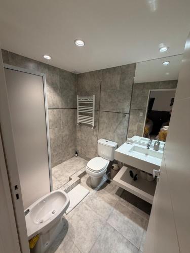 a bathroom with a toilet and a sink and a shower at Departamento excelente ubicación in Comodoro Rivadavia