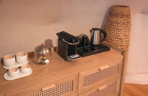 a coffee maker on top of a wooden cabinet at By Sayyar in Abu Dhabi