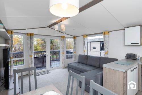 a living room with a couch and a table at Vacant Nests Seton Sands Kings Barns Starlink in Longniddry