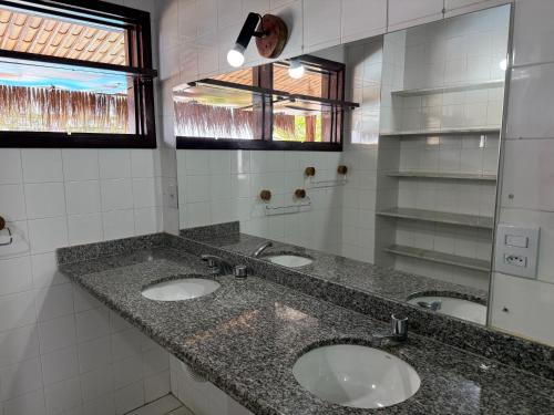 a bathroom with three sinks and a mirror at Oceana Suites Vila da Mata in Pipa