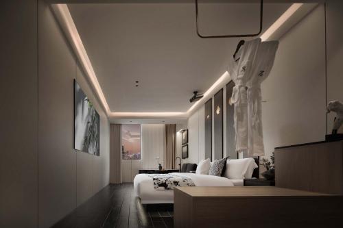 a hotel room with a bed and a couch at Chongqing INS·Wanbai Terrace River View Hotel (Jiefangbei Hongyadong Branch) in Nan'an