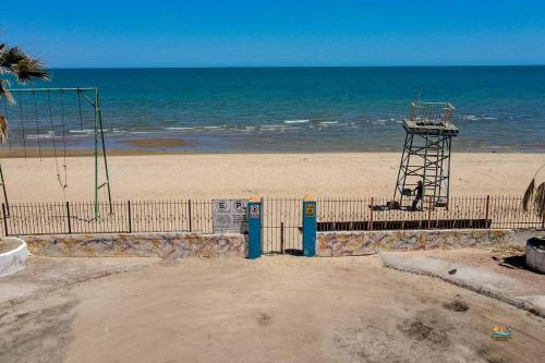 a beach with a volley ball goal and the ocean at Condo 4, In town and steps to the beach and Malecon in San Felipe