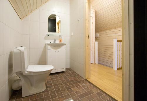 a bathroom with a toilet and a sink at Holiday Houses Saimaa Gardens in Imatra