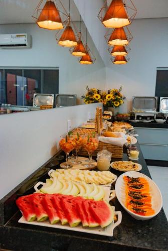a buffet with many different types of food on a counter at Araguaia Plaza Hotel in Conceição do Araguaia