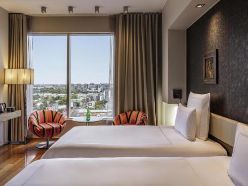 Postel nebo postele na pokoji v ubytování Swissotel Tallinn