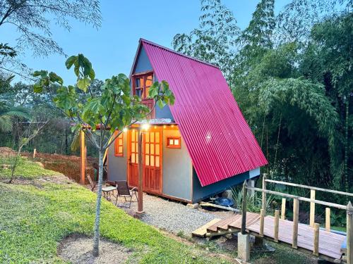 a small house with a red roof at Cabaña con jacuzzi en Venecia in Venecia