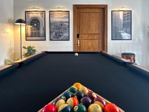 a pool table in a living room with at DTW Suites in Romulus