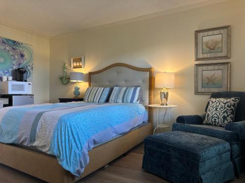 a bedroom with a large bed and a chair at The Inn at Southern Oaks in Lavonia