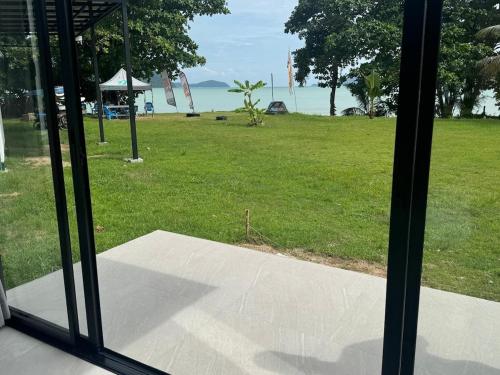 a view of a park from a window at Sunrise Beachfront Rawai in Ban Saiyuan (1)