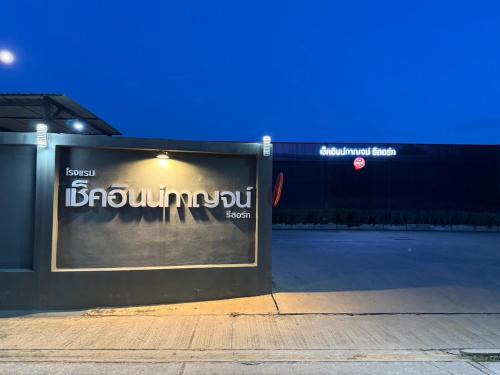 a sign on the side of a building at night at CheckInn Kan Resort Kanchanaburi in Kanchanaburi City