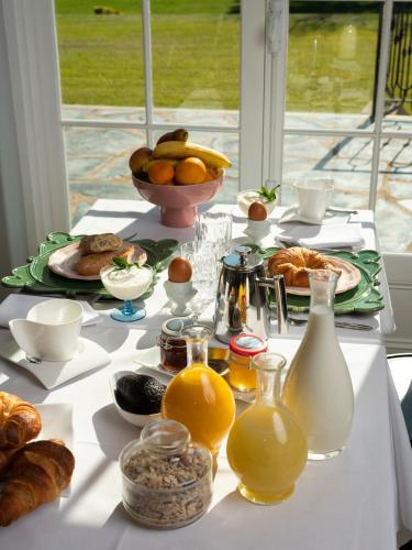 a white table with breakfast foods and drinks on it at Le Mas Barossa in Rowland Flat