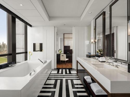 a bathroom with two sinks and a tub at Fairmont Wuhan in Wuhan