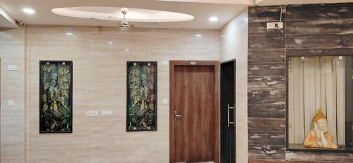 a hallway with three paintings on the wall at Raghunath Jammu in Jammu