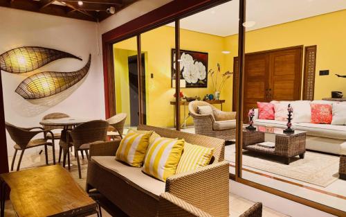 a living room with a couch and a table at Casa Acantilado Oslob - 3BR in Oslob