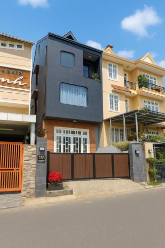 a building with a gate and a fence at Midas Home in Da Lat
