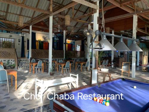a pool table in a pavilion with tables and chairs at Happy Days Guest House in Ko Kood
