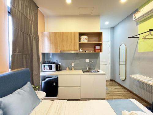 a small kitchen with a bed and a sink at DreamHome - Starry in Ho Chi Minh City