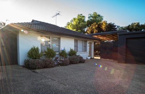 a house with a driveway in front of it at Relax Inn in Mulwala