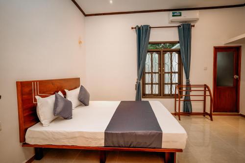 Postel nebo postele na pokoji v ubytování Raamvilla