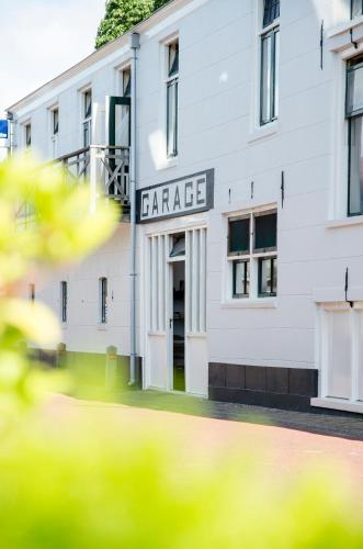 a white building with a sign that reads garage at HCR Teernstra in Balk