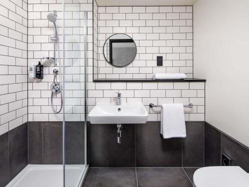 a bathroom with a sink and a shower at ibis London Sutton Point in Sutton